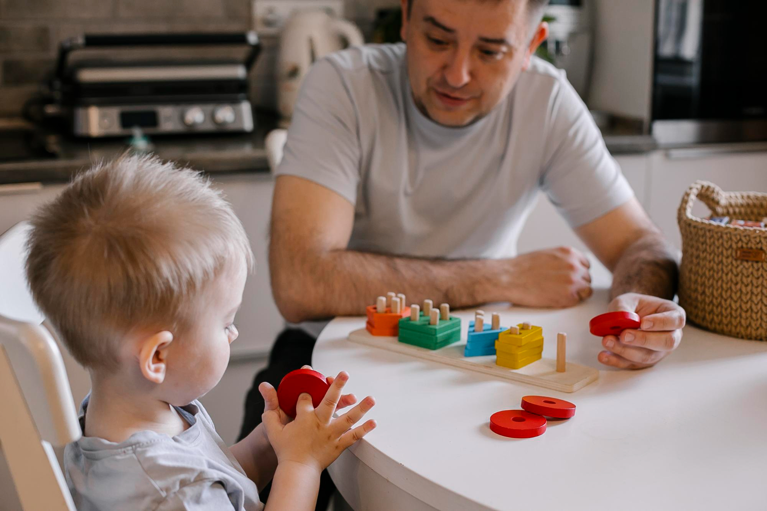 Young child, parent and Wellness Care practitioner playing together in Melbourne as part of early childhood intervention supports