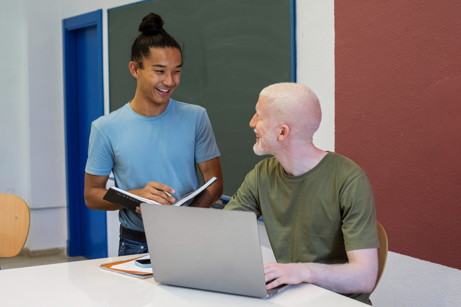 Support worker helping an NDIS participant with employment or education tasks on a laptop in Melbourne.