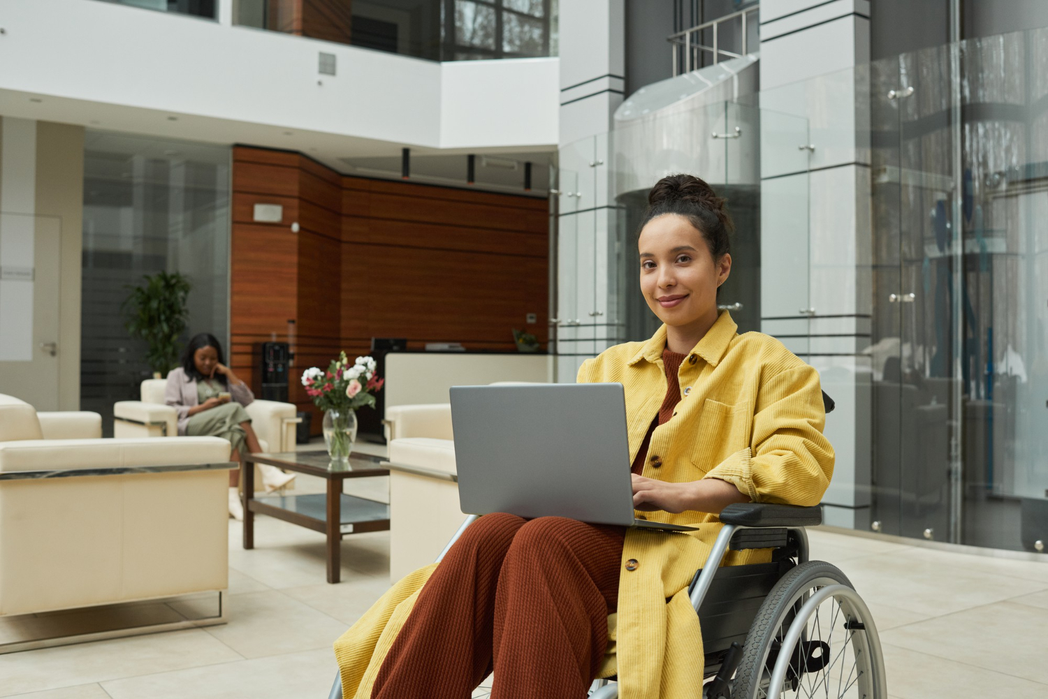 Services Support worker helping an NDIS participant with employment or education tasks on a laptop in Melbourne.