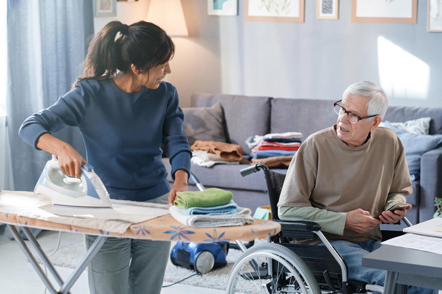 Services Support worker assisting an NDIS participant with household cleaning tasks in Melbourne.